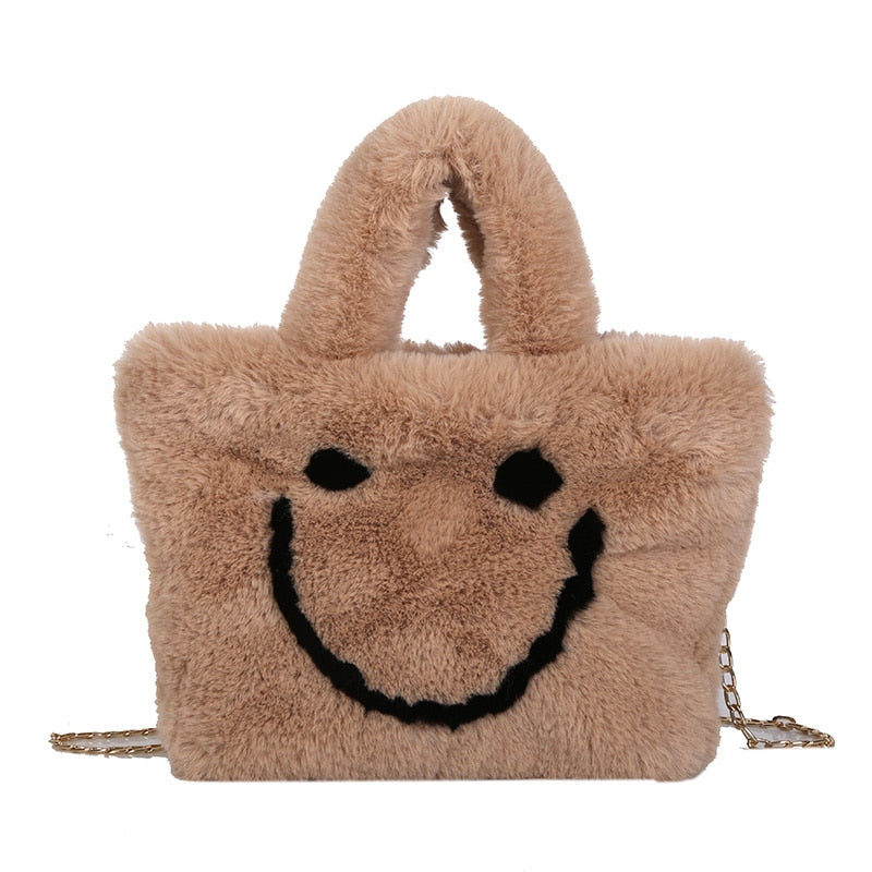 Women aplush smiley handbag