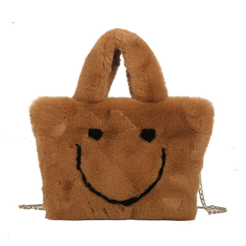 Women aplush smiley handbag