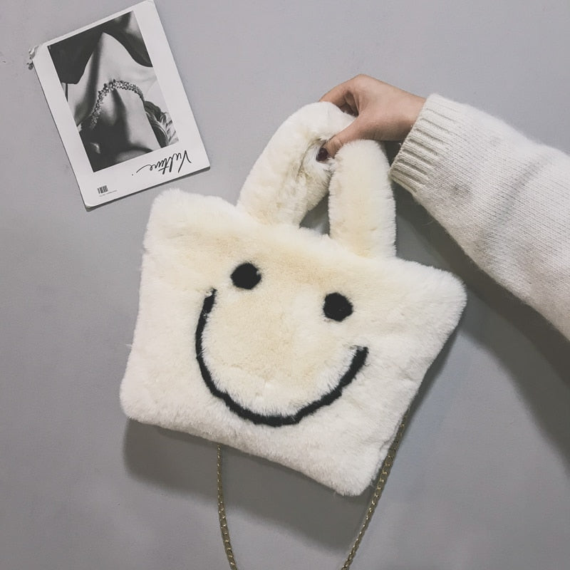 Women aplush smiley handbag