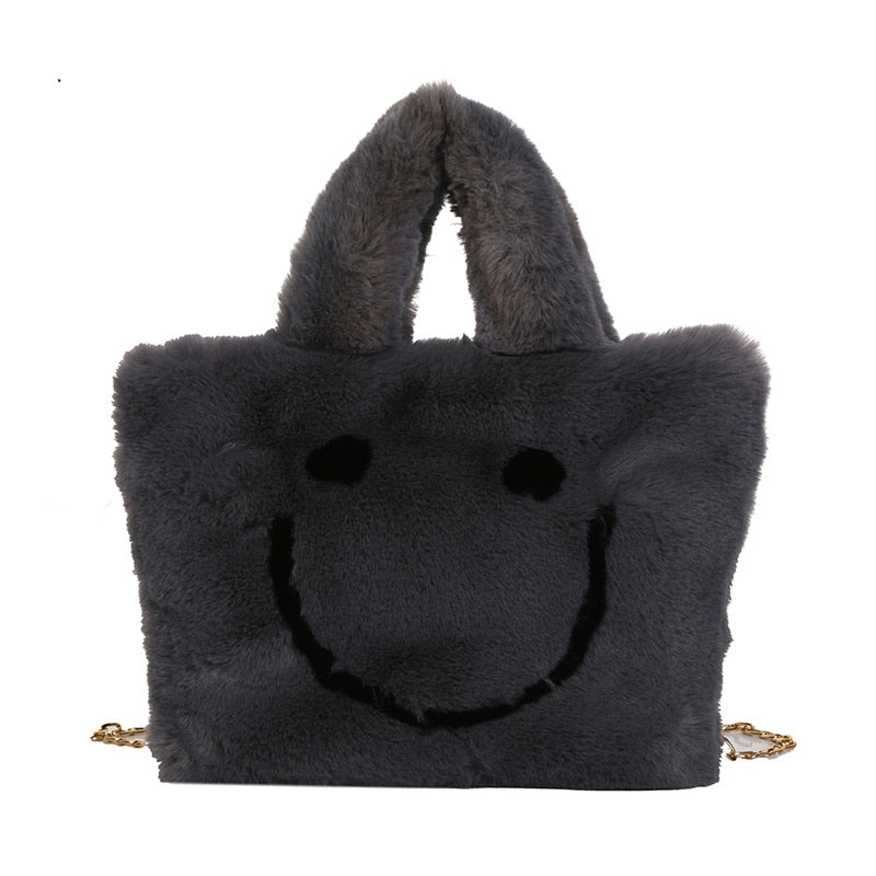 Women aplush smiley handbag