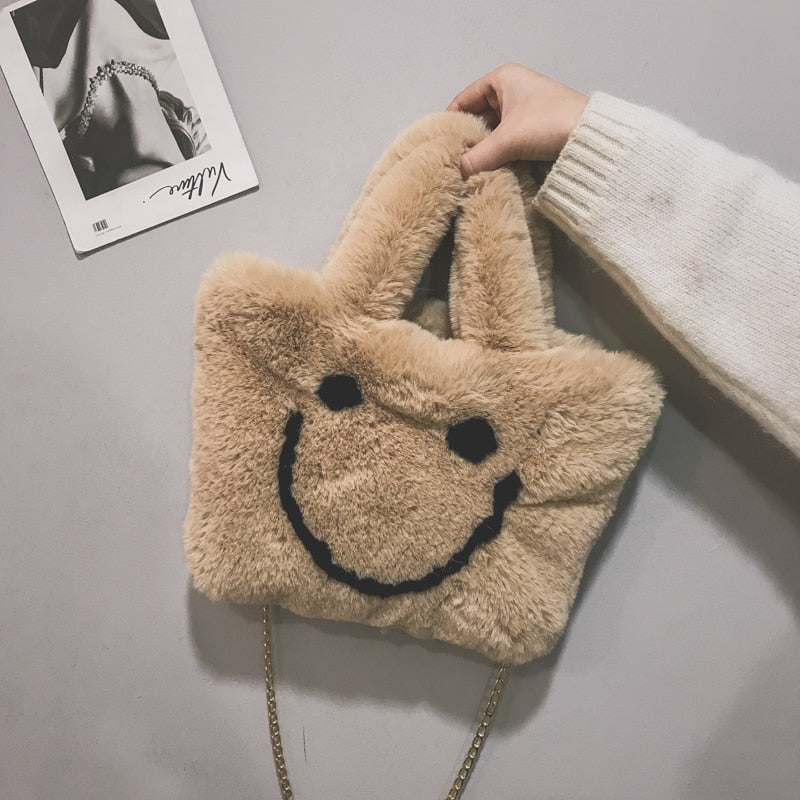 Women aplush smiley handbag