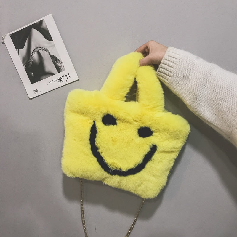 Women aplush smiley handbag